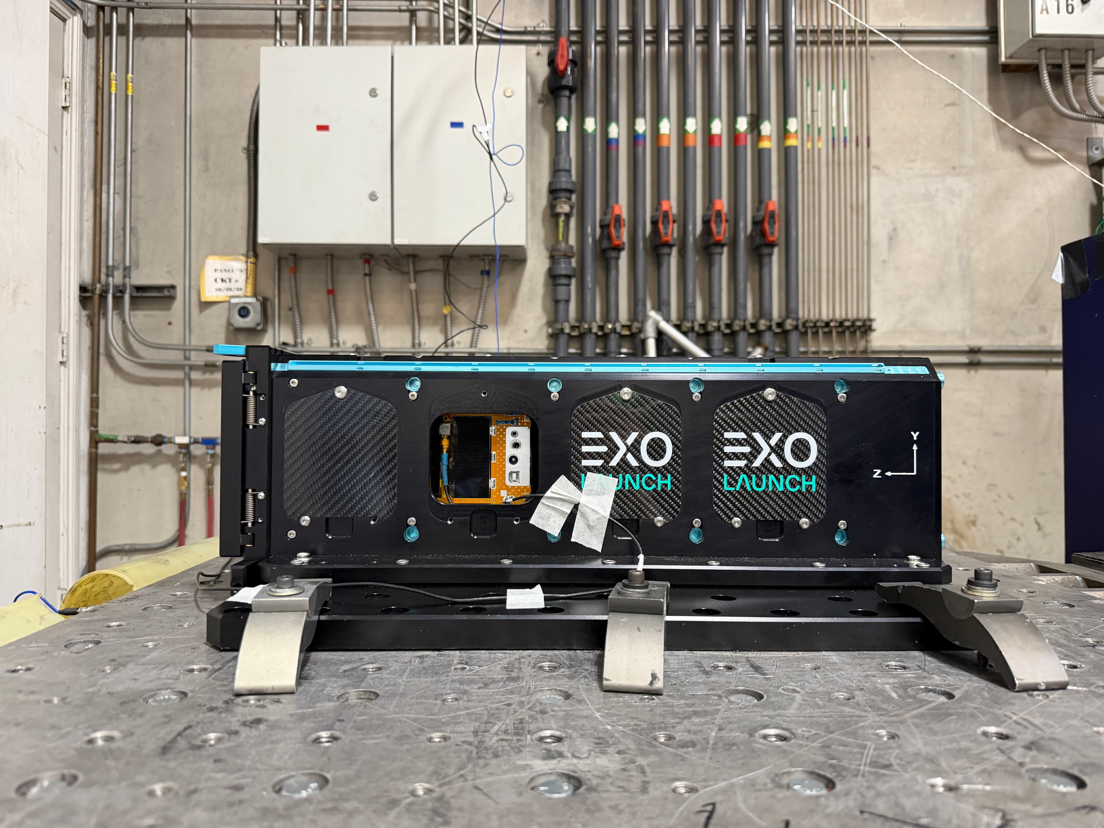 KENSAT integrated inside its EXOLaunch deployer, clamped to a vibration test table